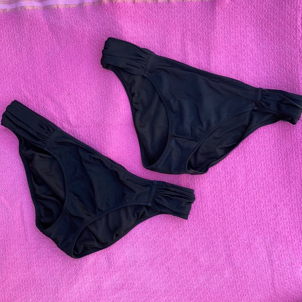 Two Victoria’s Secret black swim bottoms